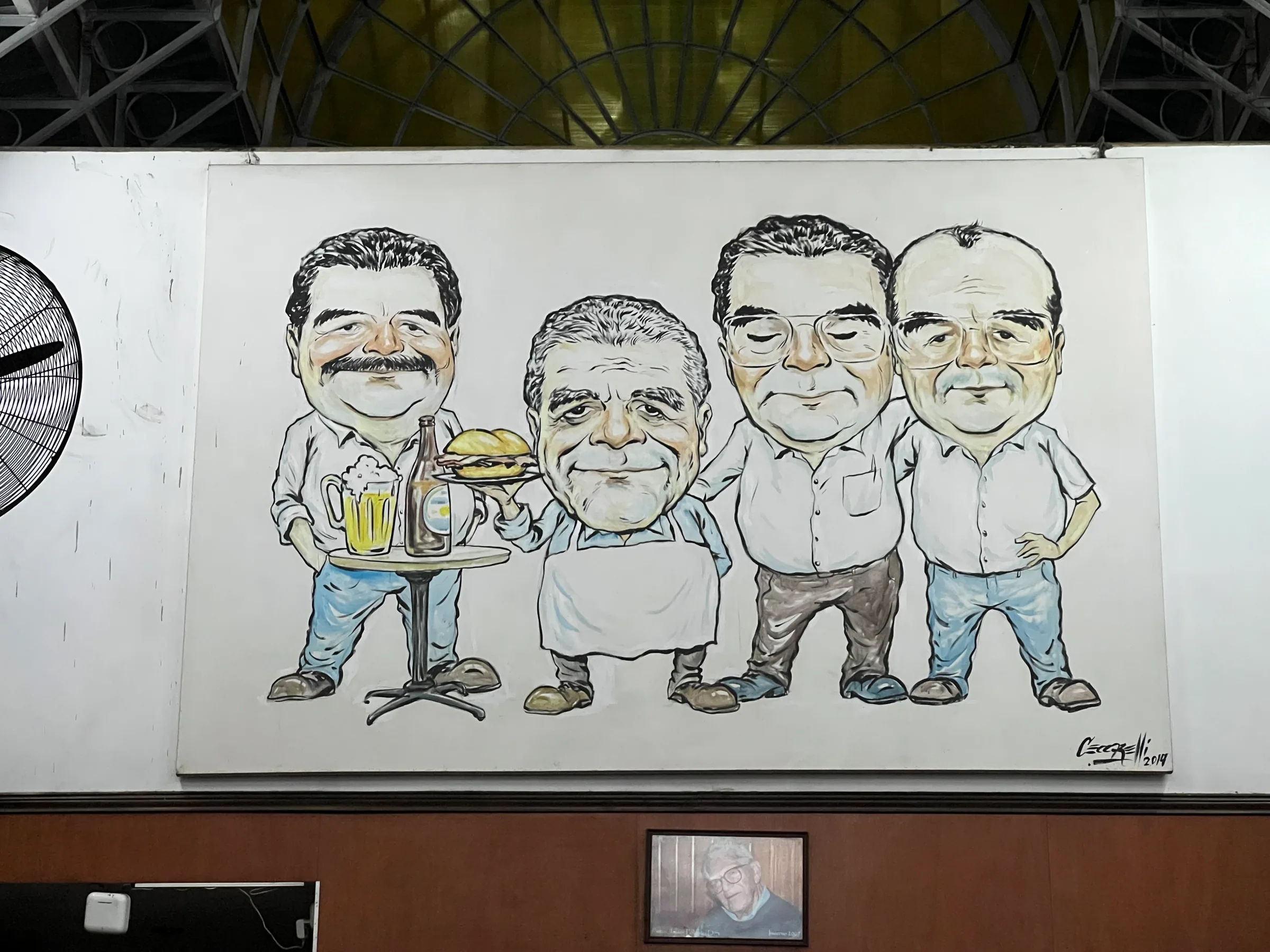 A large portrait hanging inside Juanito bar